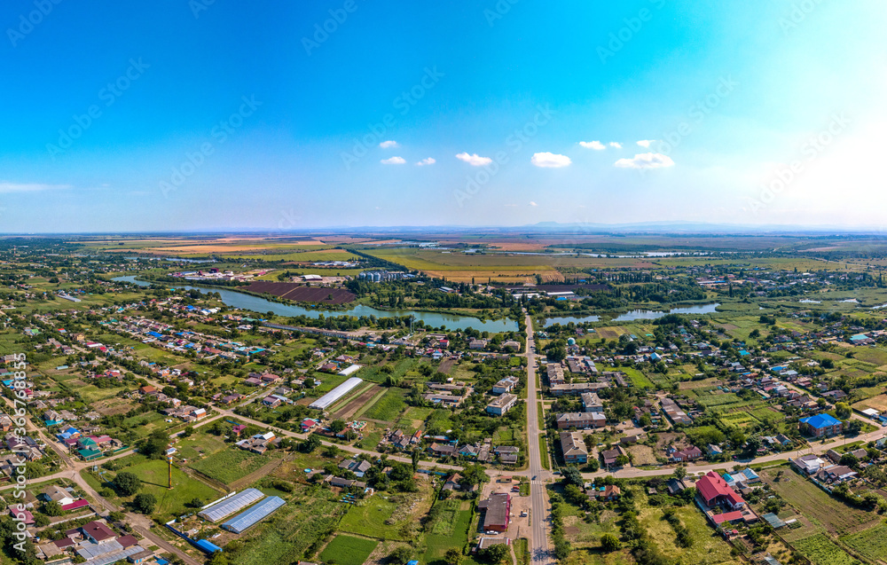the village of Lvovskoe not far from the city of Krasnodar ( Russia) - a pharmacy, streets and houses of the classic village architecture of the Kuban aerial t panorama on a summer 