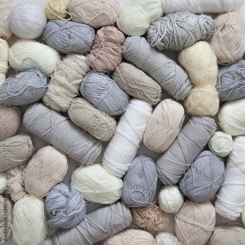 White, light, neutral and grey yarn for knitting. Top view.