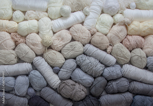 Horizontal gradient from yarn of natural shades. White, beige, gray, black and cream colors.