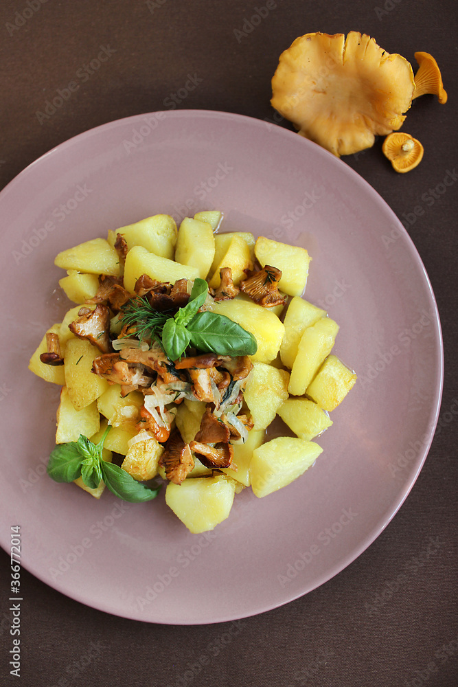 Dish with fried mushrooms and potatoes seasoned with sauce Dish with fried mushrooms and potatoes seasoned with sauce