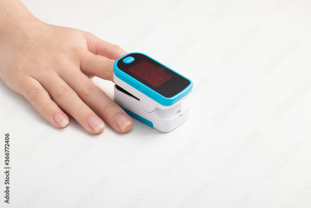 Saturation of hemoglobin of blood with oxygen. Female finger in a pulse oximeter Saturation of hemoglobin of blood with oxygen. Female finger in a pulse oximeter