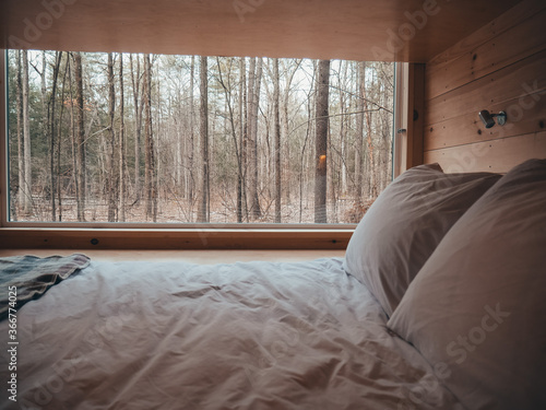 getaway tiny home cabin bedroom in the morning camping in the woods