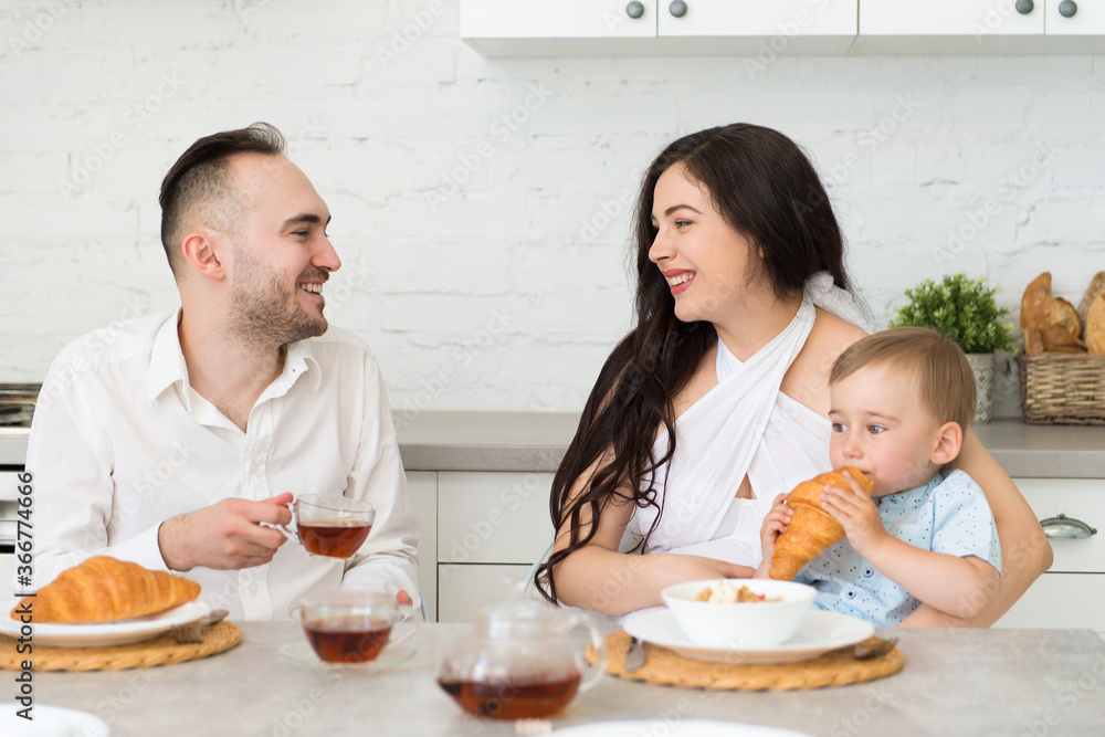 happy family in home kitchen married couple with small child