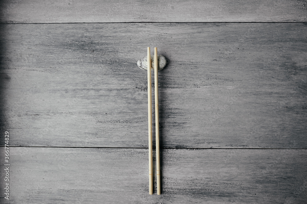 wooden chopsticks for chinese asian food on light wooden background and stone top view. Asian cutlery. wooden chopsticks for chinese asian food on light wooden background and stone top view. Asian cutlery.