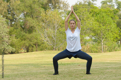 Young beautiful woman exercising at the park outdoors © Ranta Images