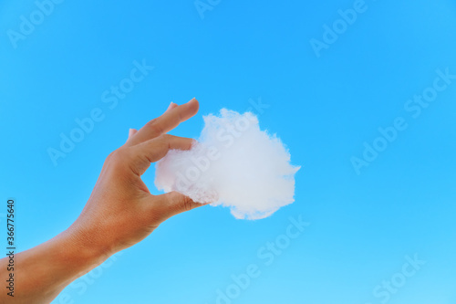 White cloud in hand against the blue sky.