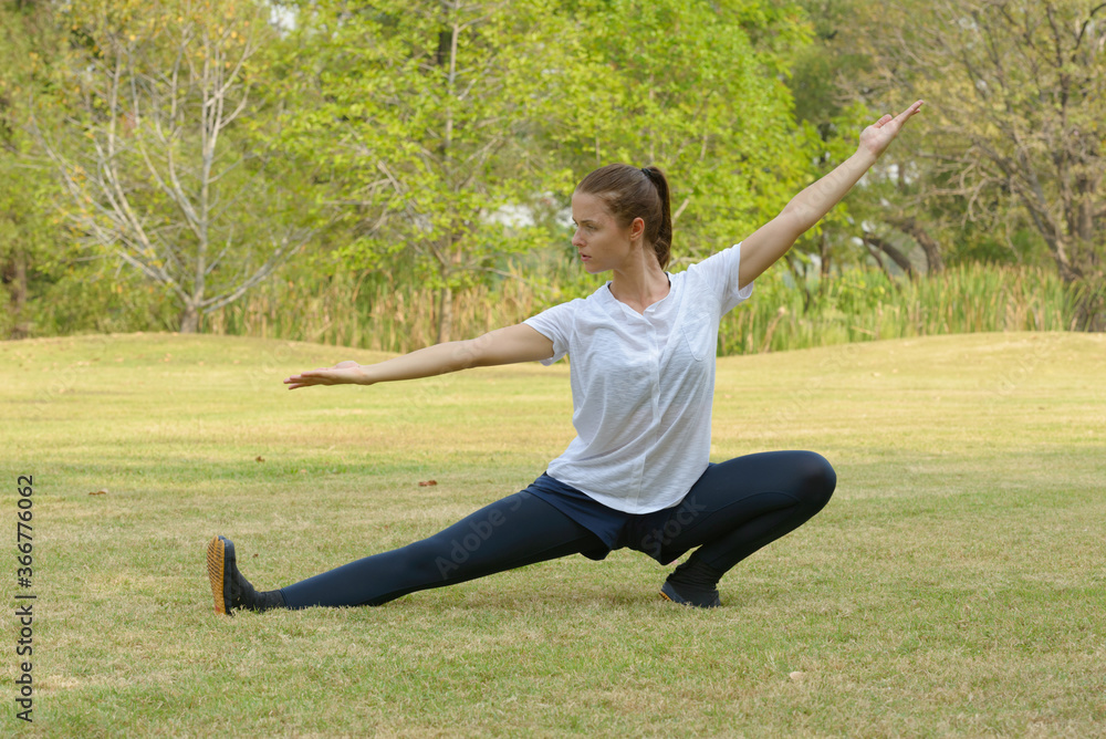 Young beautiful woman exercising at the park outdoors Young beautiful woman exercising at the park outdoors