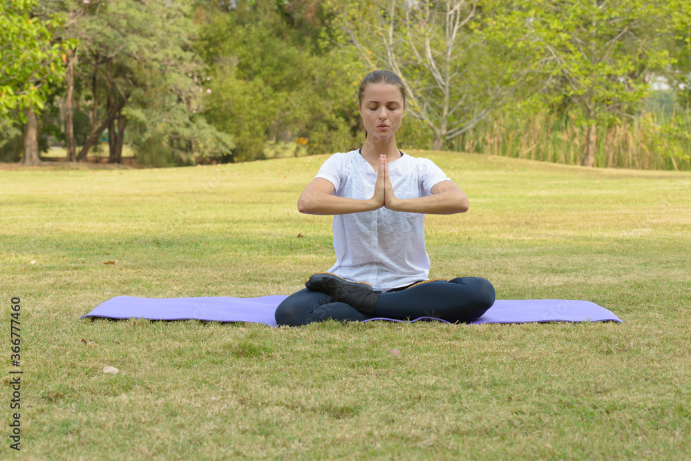 Young beautiful woman exercising at the park outdoors Young beautiful woman exercising at the park outdoors