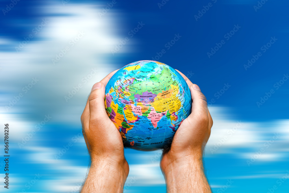Conceptual symbol human hands surrounding the Earth world globe. the sky in motion Conceptual symbol human hands surrounding the Earth world globe. the sky in motion