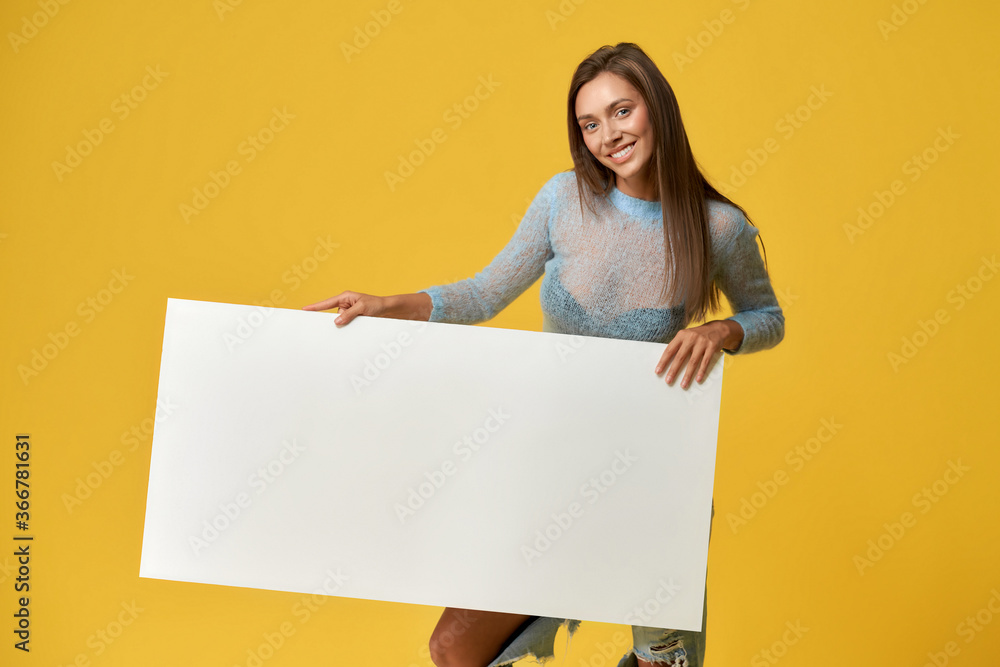 Joyful girl holding blank cardboard poster Joyful girl holding blank cardboard poster