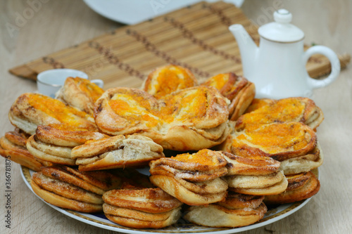 Delicious pies on a beautiful plate on the background of a tea set