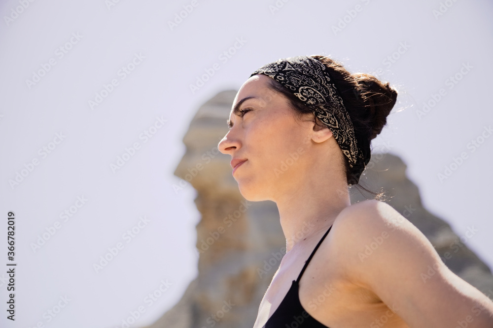 Young active woman practicing yoga in desert on sunny day, health and active life concept Young active woman practicing yoga in desert on sunny day, health and active life concept