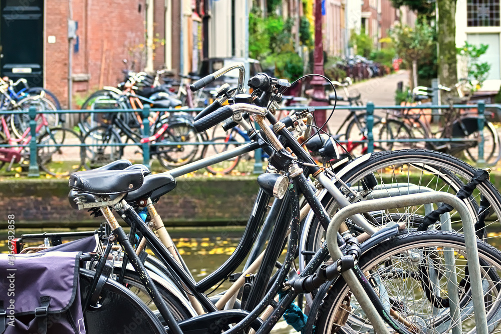 Bicycles parked on both sides of a canal in Amsterdam, Netherlands