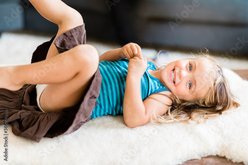 Obraz na plátně Happy toddler girl lying down