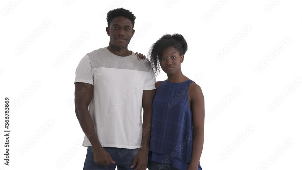 Portrait of young African American couple giving high five. raising together hands above their shoulders and slapping flats of palms. Isolated on white Portrait of young African American couple giving high five. raising together hands above their shoulders and slapping flats of palms. Isolated on white