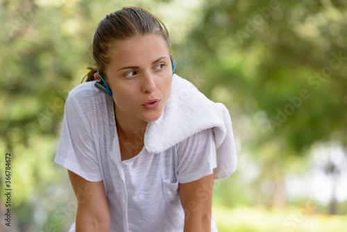 Young beautiful woman exercising at the park outdoors