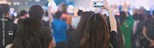 web banner nightlife and activity of people in new normal with asian woman take photo in outdoor concert with soft focus background