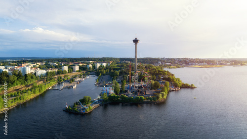 Summer panorama of the Tampere city at sunset. View from the lake. Sarkanniemi amusement park with Nasinneula tower. photo