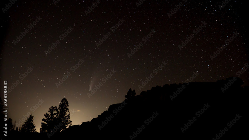 Comet Neowise soaring above the starry northwestern sky.