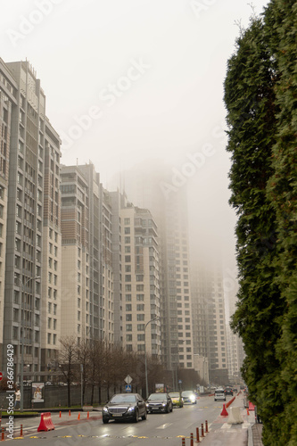 Skyscrapers in the early foggy morning near the city surroundings.