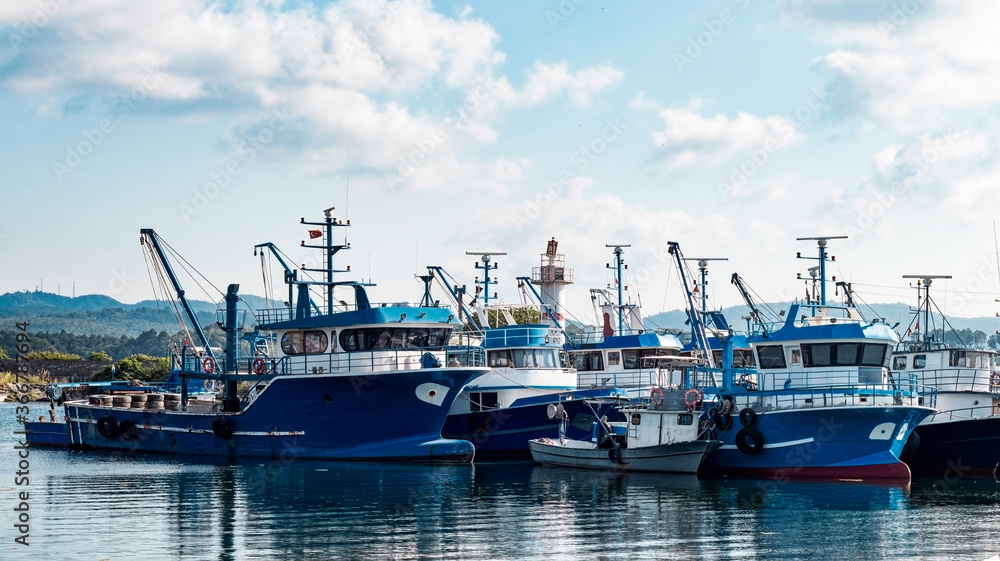 blue fishing boats on the port and clouds on clear sky. Landscape photography. marine concept wallpaper