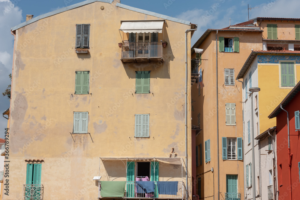 Old, vintage residential building. Windows with shutters. Menton, south of France.  