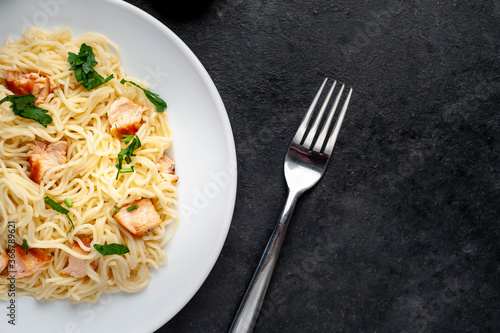  salmon pasta on stone background with copy space for your text