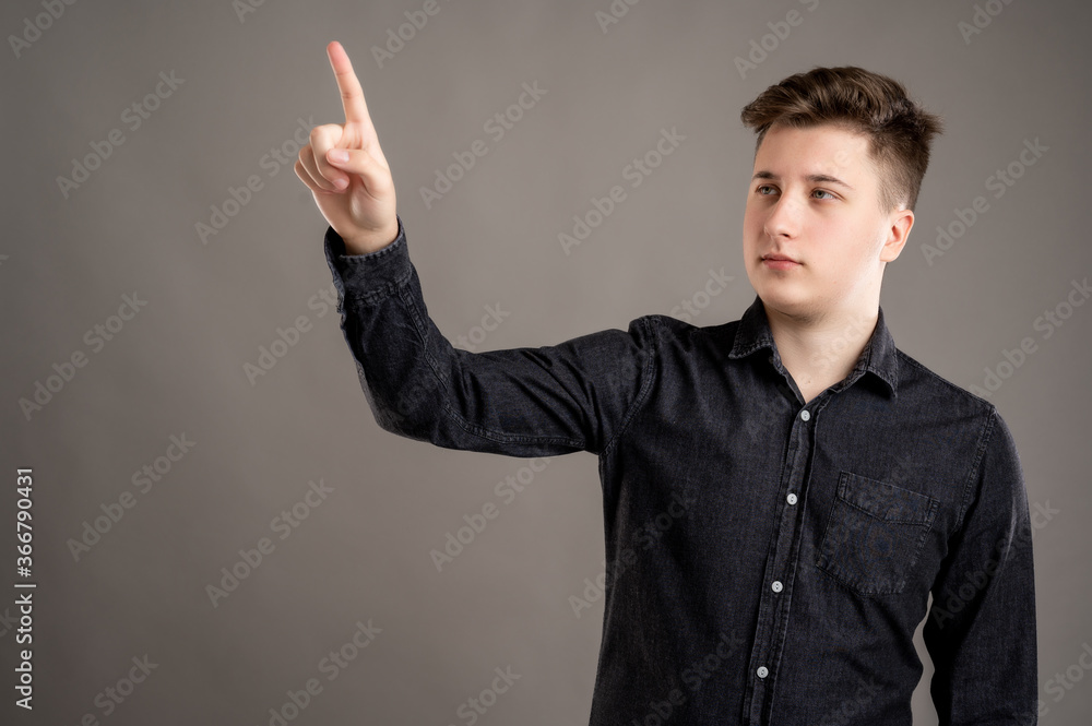 Portrait of serious stylish attractive man dressed in casual black shirt using touchscreen Portrait of serious stylish attractive man dressed in casual black shirt using touchscreen