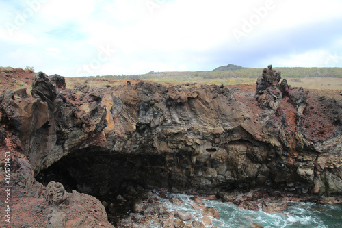 Volcanic coastal landscape at Ana Kakenga on Easter Island, Rapa Nui, Polynesia, Chile, South America 