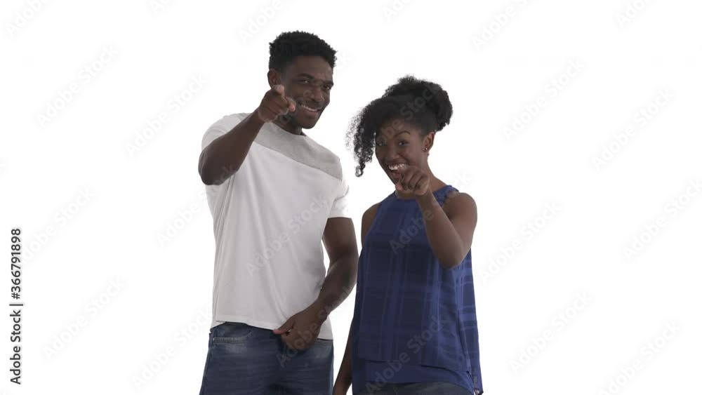 Portrait of attractive black couple pointing with index finger on camera indicating somebody or making someone feel included, nodding in approval isolated on white background Portrait of attractive black couple pointing with index finger on camera indicating somebody or making someone feel included, nodding in approval isolated on white background