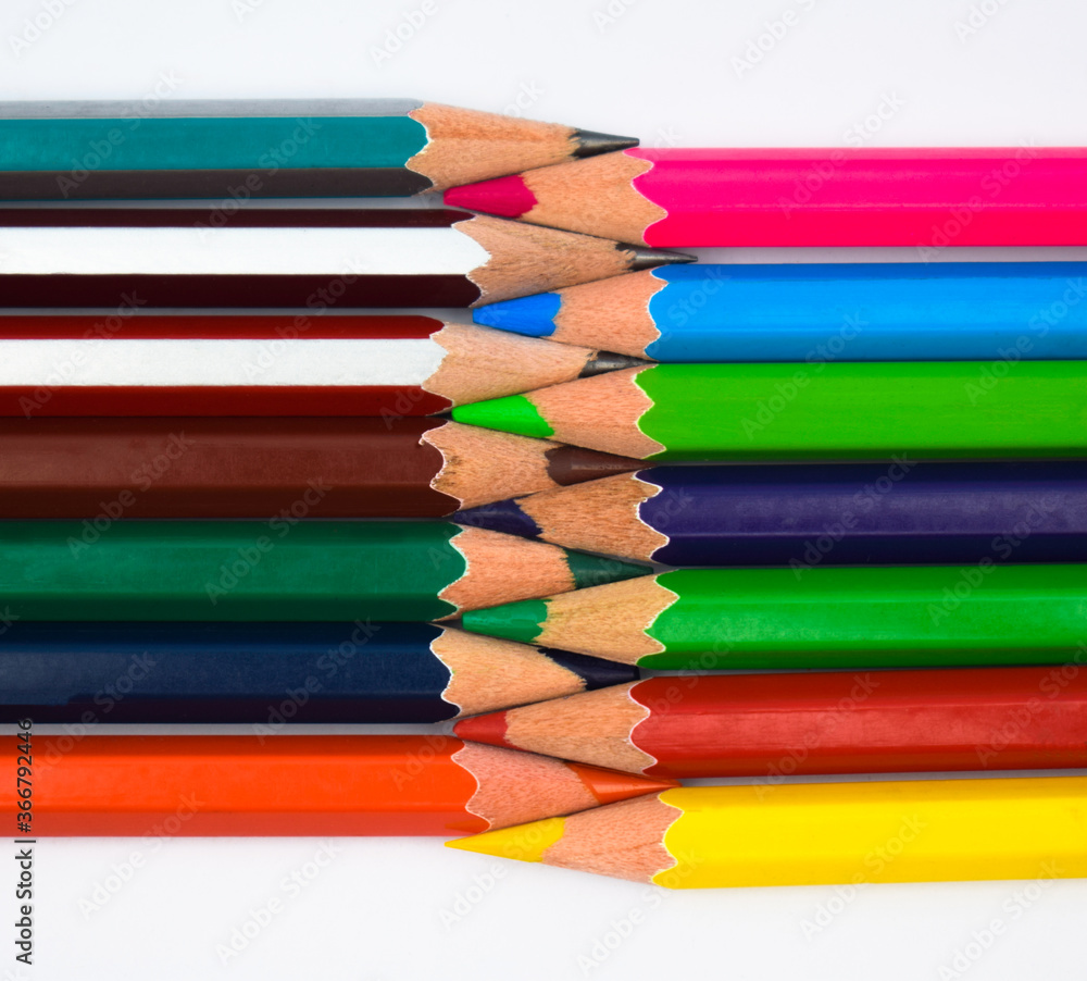A zigzagged arrangement of two different row of different color wood pencil crayons A zigzagged arrangement of two different row of different color wood pencil crayons