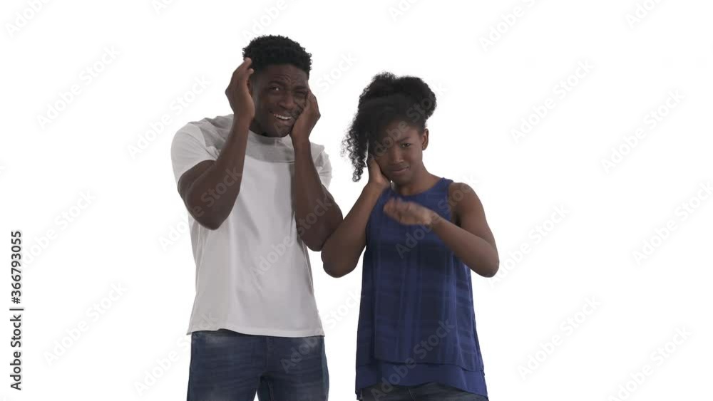 Portrait of young black couple covering their ears with hands begging someone to be quiet isolated on white background Portrait of young black couple covering their ears with hands begging someone to be quiet isolated on white background