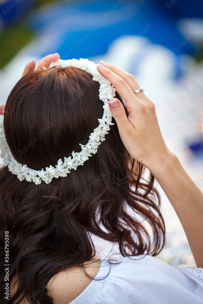 Naklejka premium The bride touches the tiara on her head