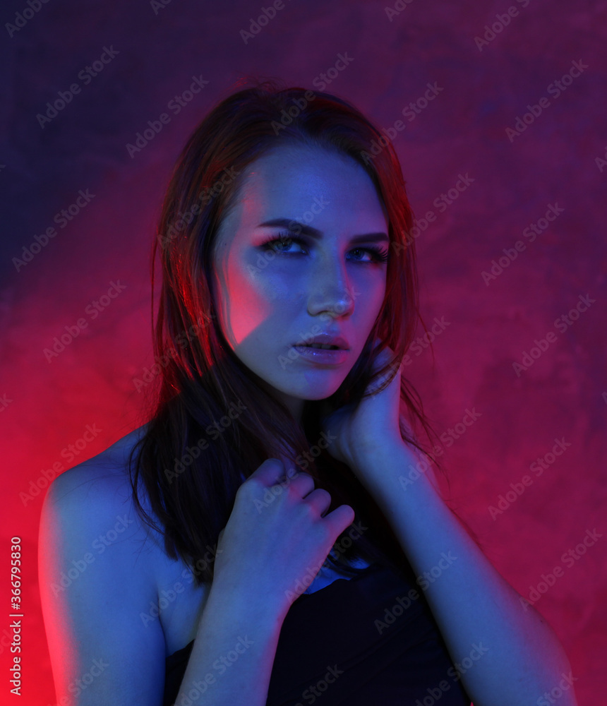 Girl in blue neon light in studio portrait Girl in blue neon light in studio portrait