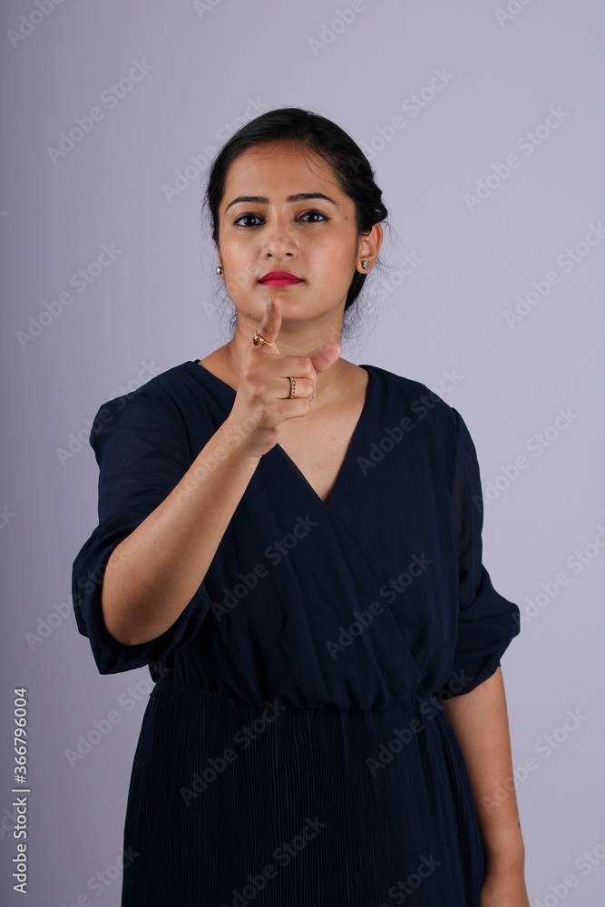Beautiful Indian girl taking tough stance and saying no, stop with her gesture. Beautiful Indian girl taking tough stance and saying no, stop with her gesture.