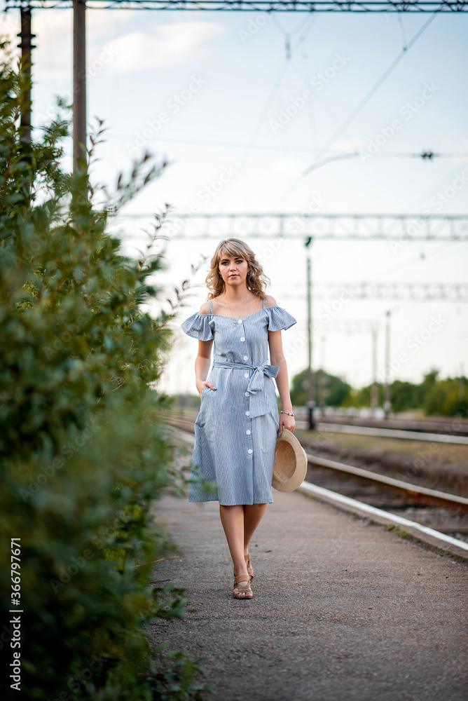 girl  on the background of railway tracks