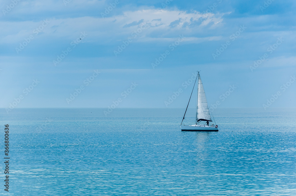 a sailboat anchored off the coast of Mar del Plata, Argentina, on a sunny day