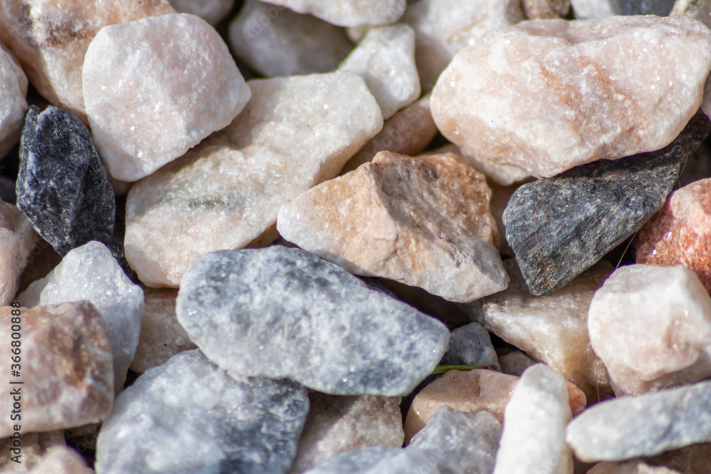 Raw rocks and minerals as natural stones background with crushed and rough material at a rough coast or rocky beach show nuggets and sandstones in harmonic pastel colors Raw rocks and minerals as natural stones background with crushed and rough material at a rough coast or rocky beach show nuggets and sandstones in harmonic pastel colors