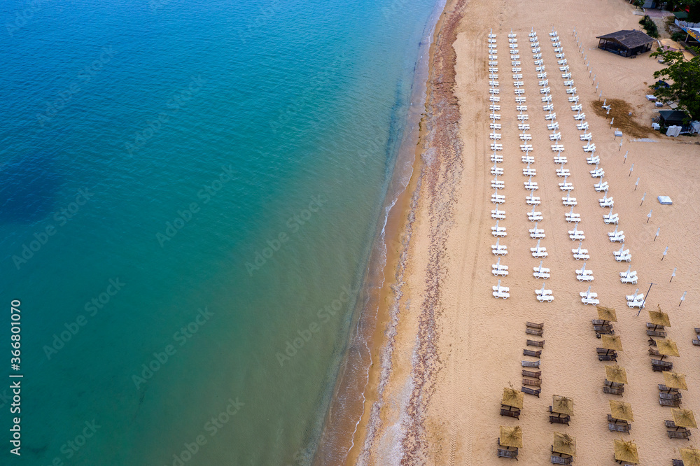 Aerial view of the beach with umbrellas. Sea beach coastline, summer holiday.