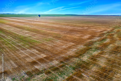 Scenic view from a drone of landscape with earth surface after harvest. Nature background