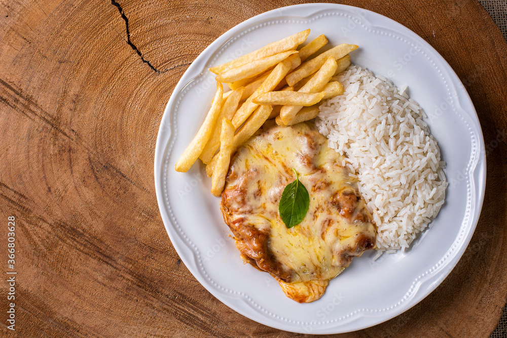 Parmegiana Steak also known as Filet Parmegiana. .Accompanied by rice and chips Parmegiana Steak also known as Filet Parmegiana. .Accompanied by rice and chips