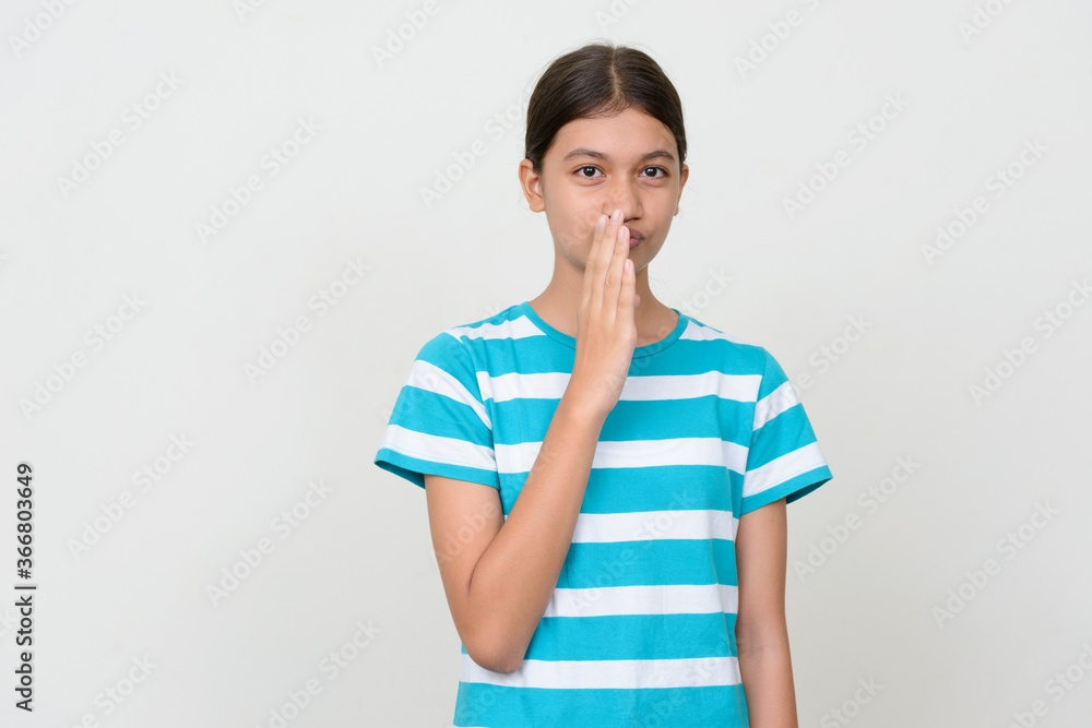 Portrait of young Asian teenage girl against white background Portrait of young Asian teenage girl against white background
