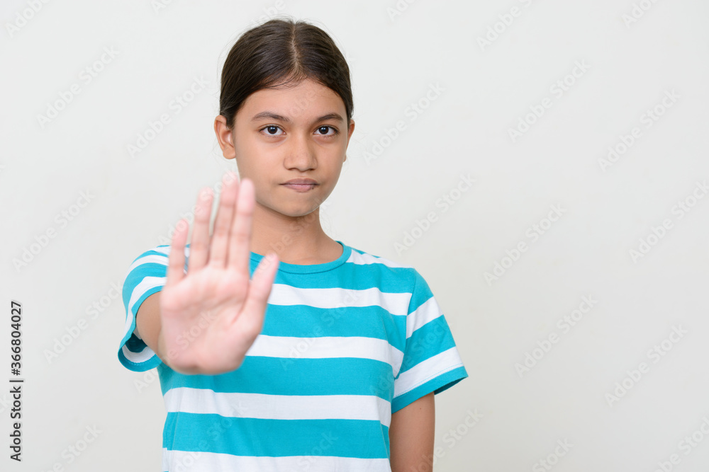 Portrait of young Asian teenage girl against white background Portrait of young Asian teenage girl against white background