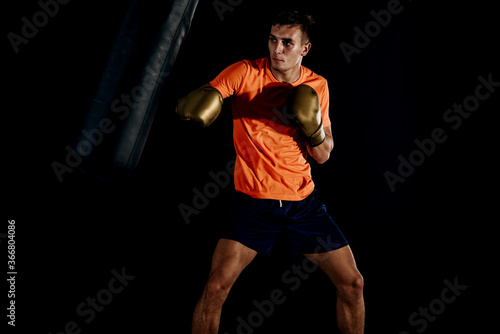 Man punching boxer bag. Boxing exercise of making punch