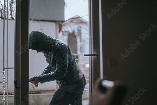 Housebreaker prepare for stealing while entering in the flat photo
