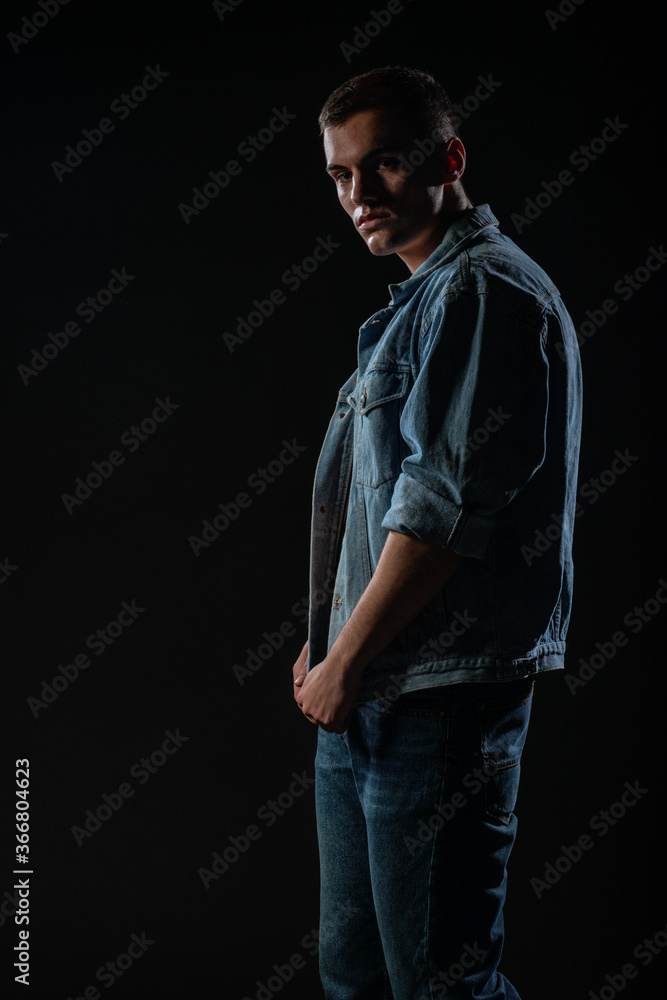Picture of a young handsome macho man with abs and open denim jacket and jeans. Picture of a young handsome macho man with abs and open denim jacket and jeans.