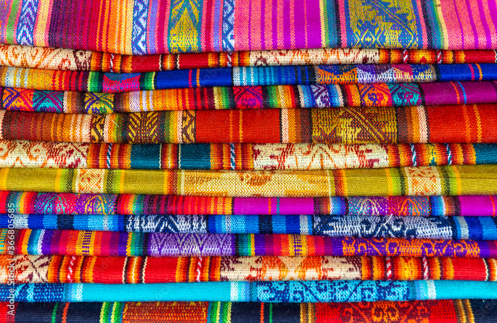 A pile of Andes fabric on the handicraft market of Cusco, Peru. A pile of Andes fabric on the handicraft market of Cusco, Peru.