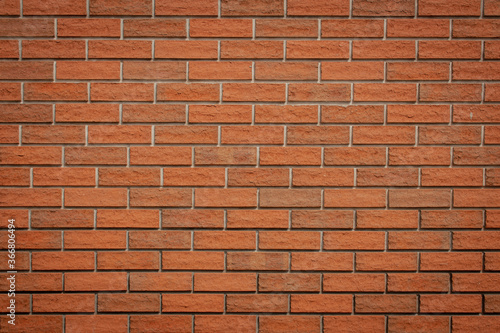 red clay brick wall, even rows of masonry