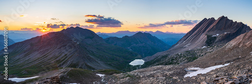 the Taillante ridge in the french Alps at sunset, idyllic mountain landscape rocky terrain and alpine lake at high altitude, panoramic view