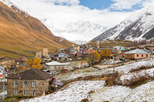 Mountain village Ushguli with medieval towers and one of the peaks of the Caucasus Mountains, Mount Shkhara in the background, Georgia, Caucasus photo